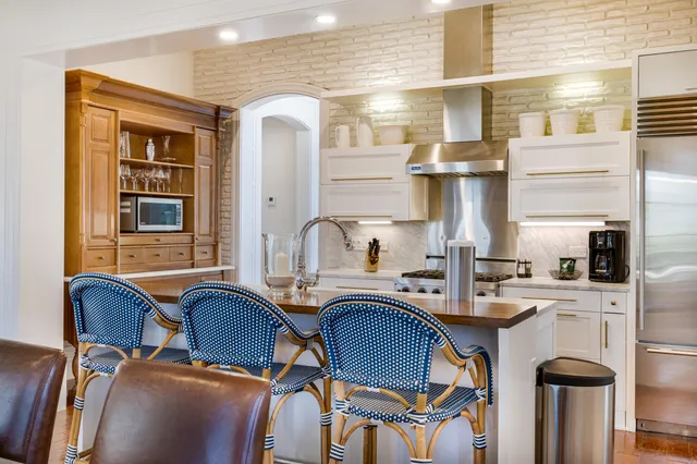 a kitchen with furniture a sink and appliances