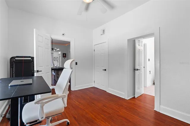 a view of a workspace with furniture and wooden floor