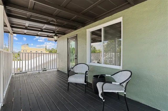 a view of a room with wooden floor and windows