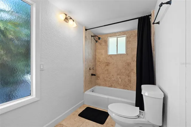 a bathroom with a toilet a sink and bathtub