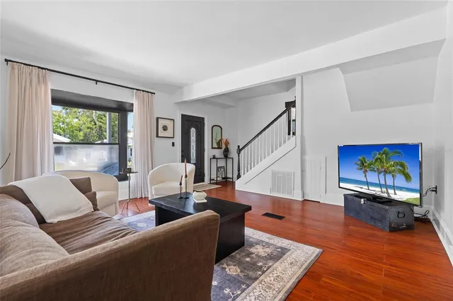 a living room with furniture and a painting on the wall