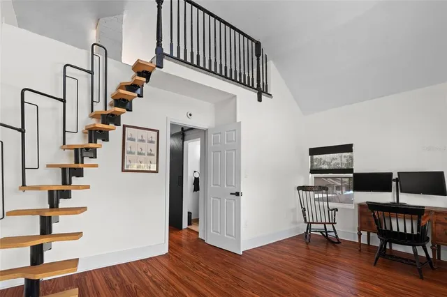 a view of entryway with dining room and wooden floor