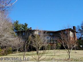 195 Mimosa Road Tryon, NC 28782 - Photo 3 of 6 a view of a tall building in a yard