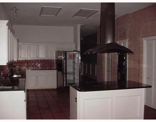 a kitchen with a refrigerator and cabinets