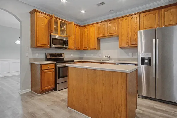 a kitchen with stainless steel appliances a refrigerator sink and microwave