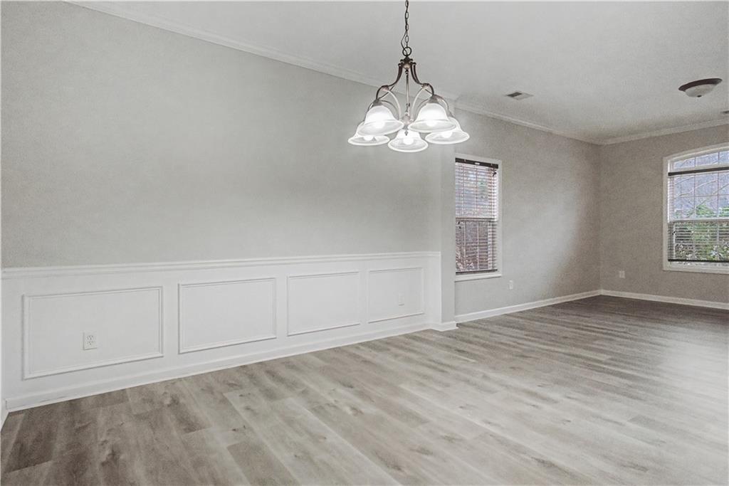 408 Long Branch Way Canton, GA 30115 - Photo 15 of 43 a view of empty room with wooden floor and chandelier