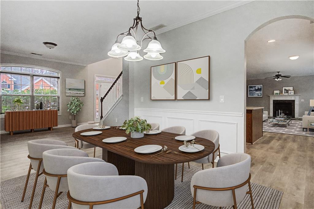408 Long Branch Way Canton, GA 30115 - Photo 17 of 43 a view of a dining room with furniture a chandelier and wooden floor