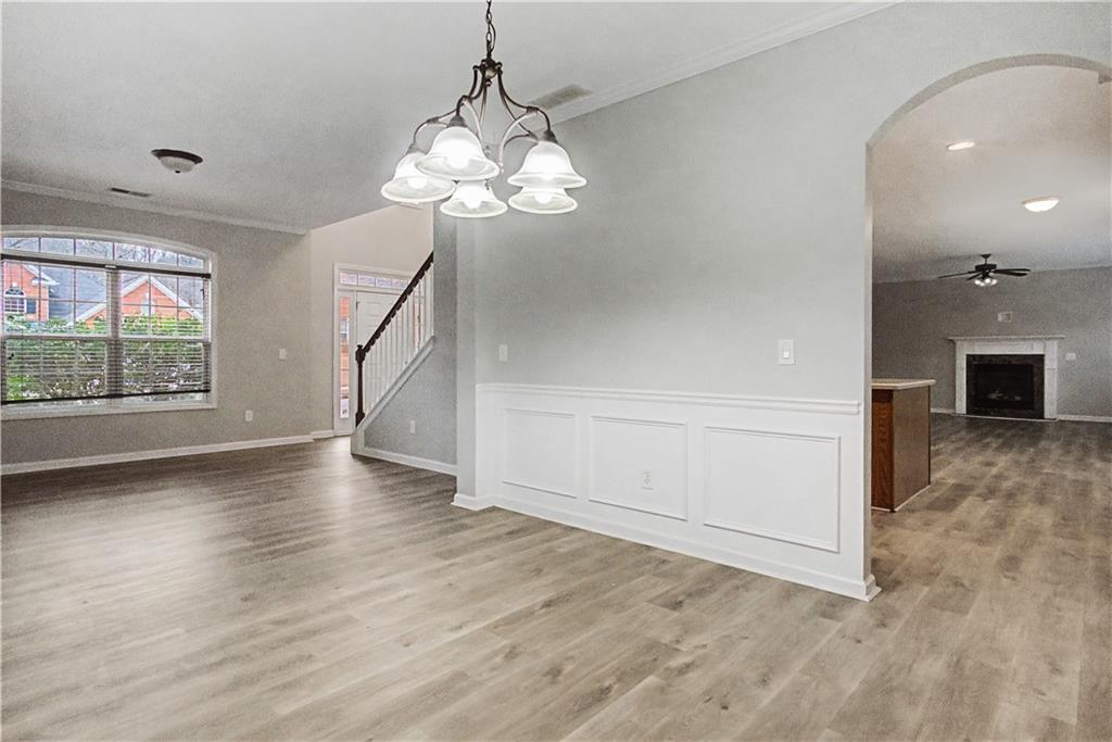 408 Long Branch Way Canton, GA 30115 - Photo 18 of 43 an empty room with wooden floor chandelier and windows