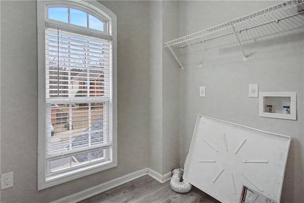 408 Long Branch Way Canton, GA 30115 - Photo 19 of 43 a view of an empty room with wooden floor and a window