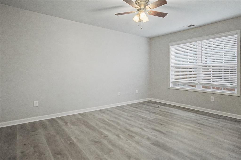 408 Long Branch Way Canton, GA 30115 - Photo 21 of 43 wooden floor in an empty room with a window