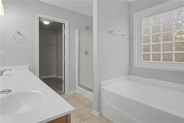 a spacious bathroom with a bathtub and a sink