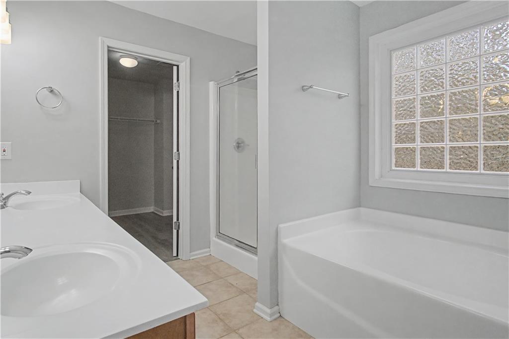 408 Long Branch Way Canton, GA 30115 - Photo 27 of 43 a spacious bathroom with a bathtub and a sink