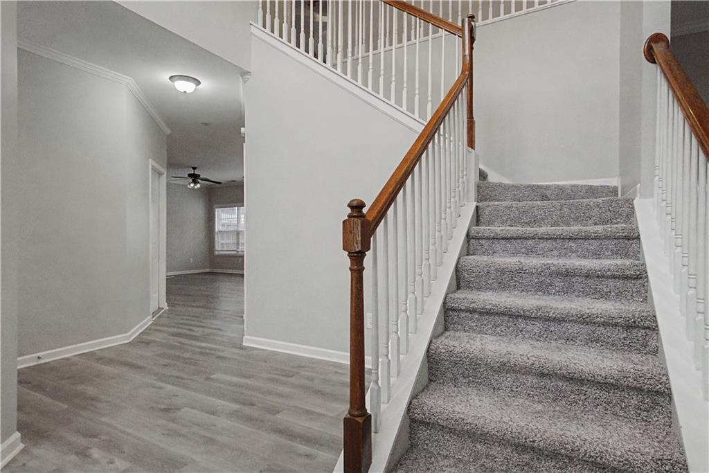 408 Long Branch Way Canton, GA 30115 - Photo 4 of 43 a view of staircase with wooden floor and white walls