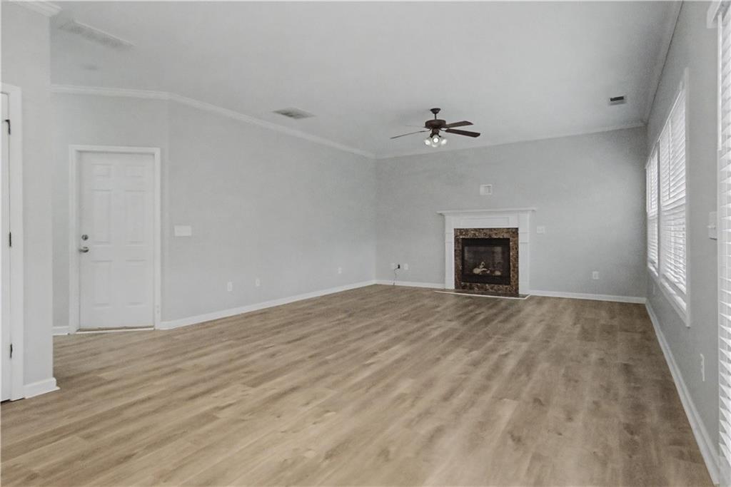 408 Long Branch Way Canton, GA 30115 - Photo 9 of 43 an empty room with fan and a fireplace