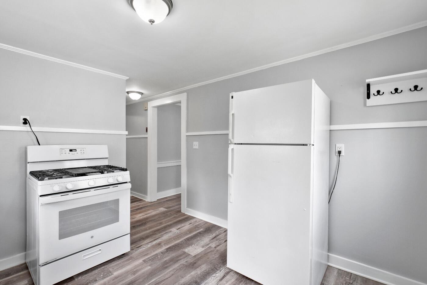 1 Gilbert Road Dennis Port, MA 02639 - Photo 11 of 27 a kitchen with a refrigerator stove and white cabinets