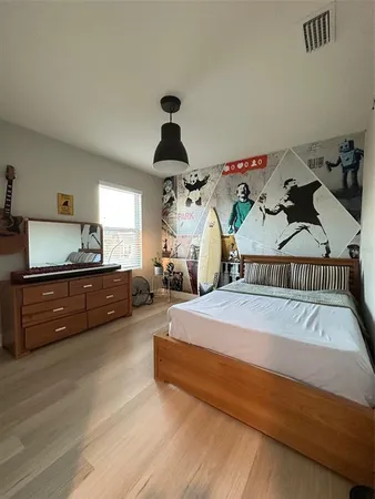 a bedroom with bed and a chandelier