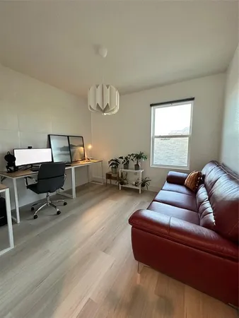 a living room with furniture a table and a window