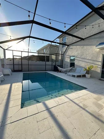 a view of a backyard with sitting area