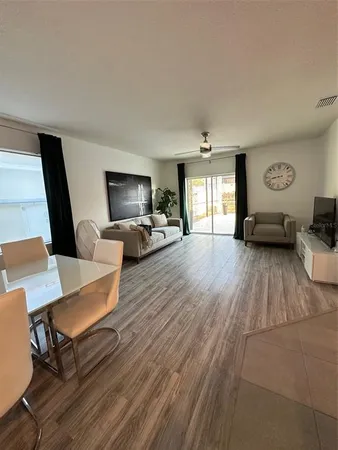 a view of a dining room with furniture and wooden floor