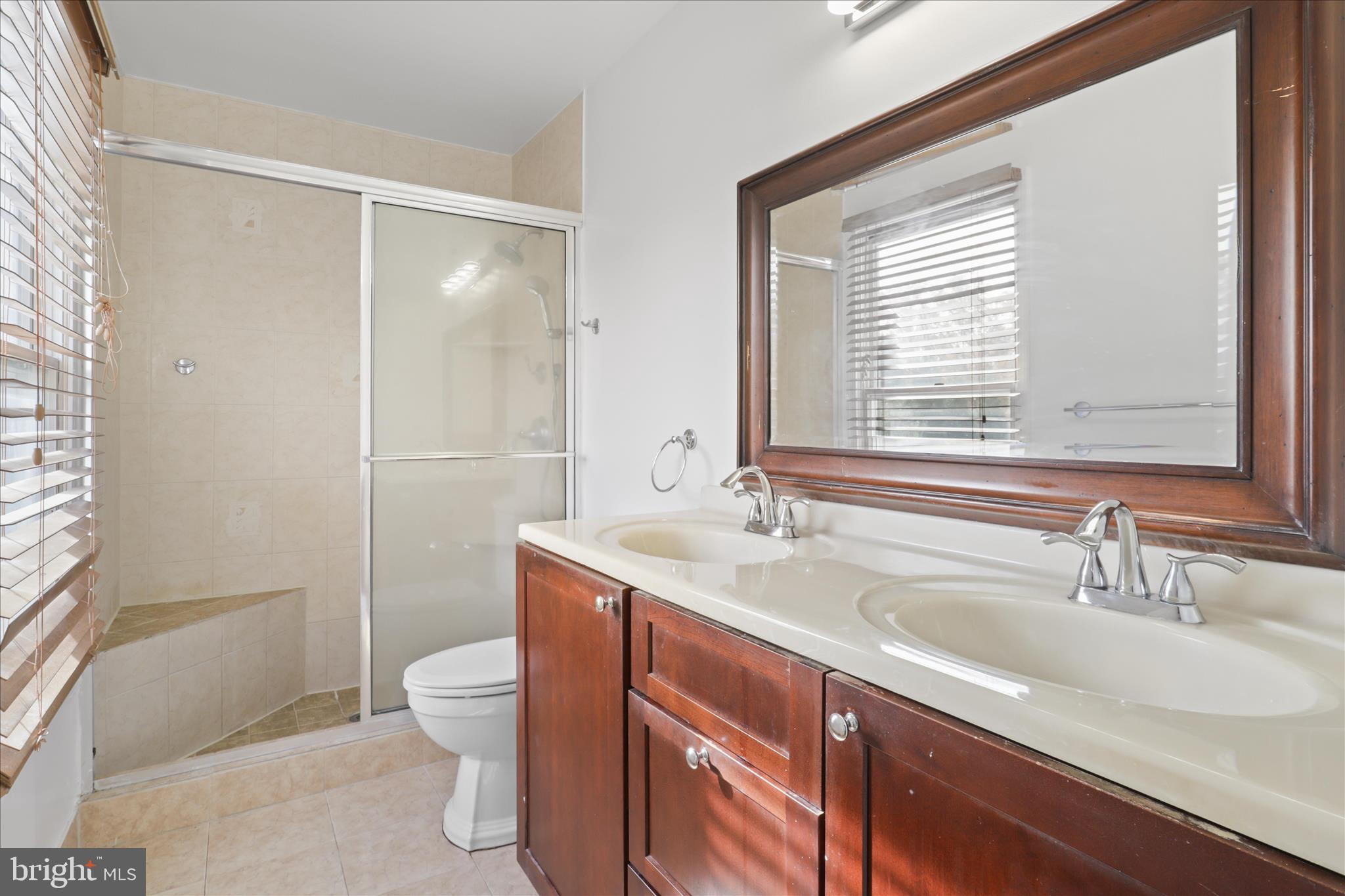 836 Utterback Store Road Great Falls, VA 22066 - Photo 11 of 30 a bathroom with a sink toilet a mirror and shower