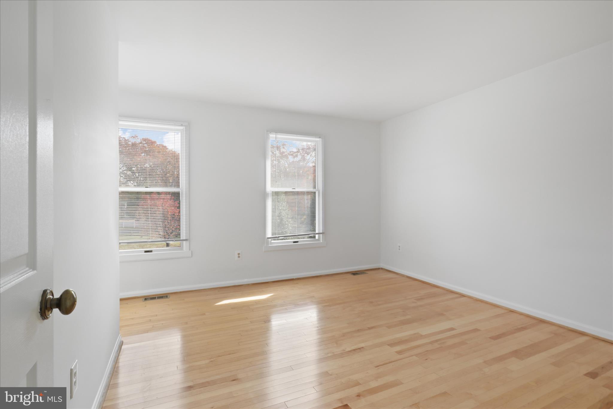 836 Utterback Store Road Great Falls, VA 22066 - Photo 12 of 30 an empty room with wooden floor and windows