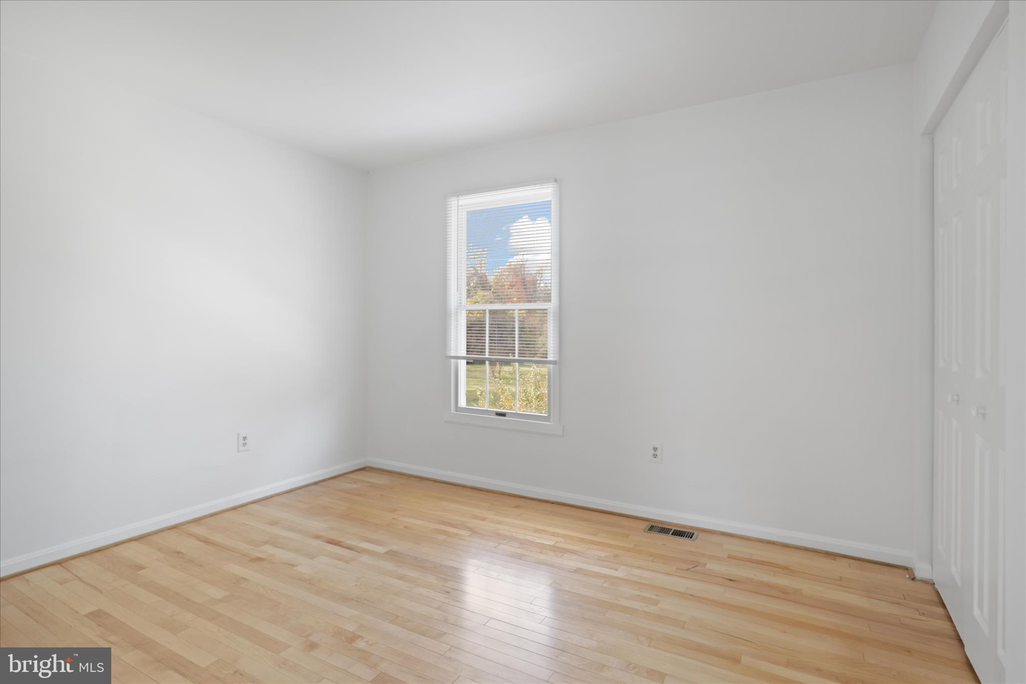 836 Utterback Store Road Great Falls, VA 22066 - Photo 13 of 30 a view of an empty room with wooden floor and a window