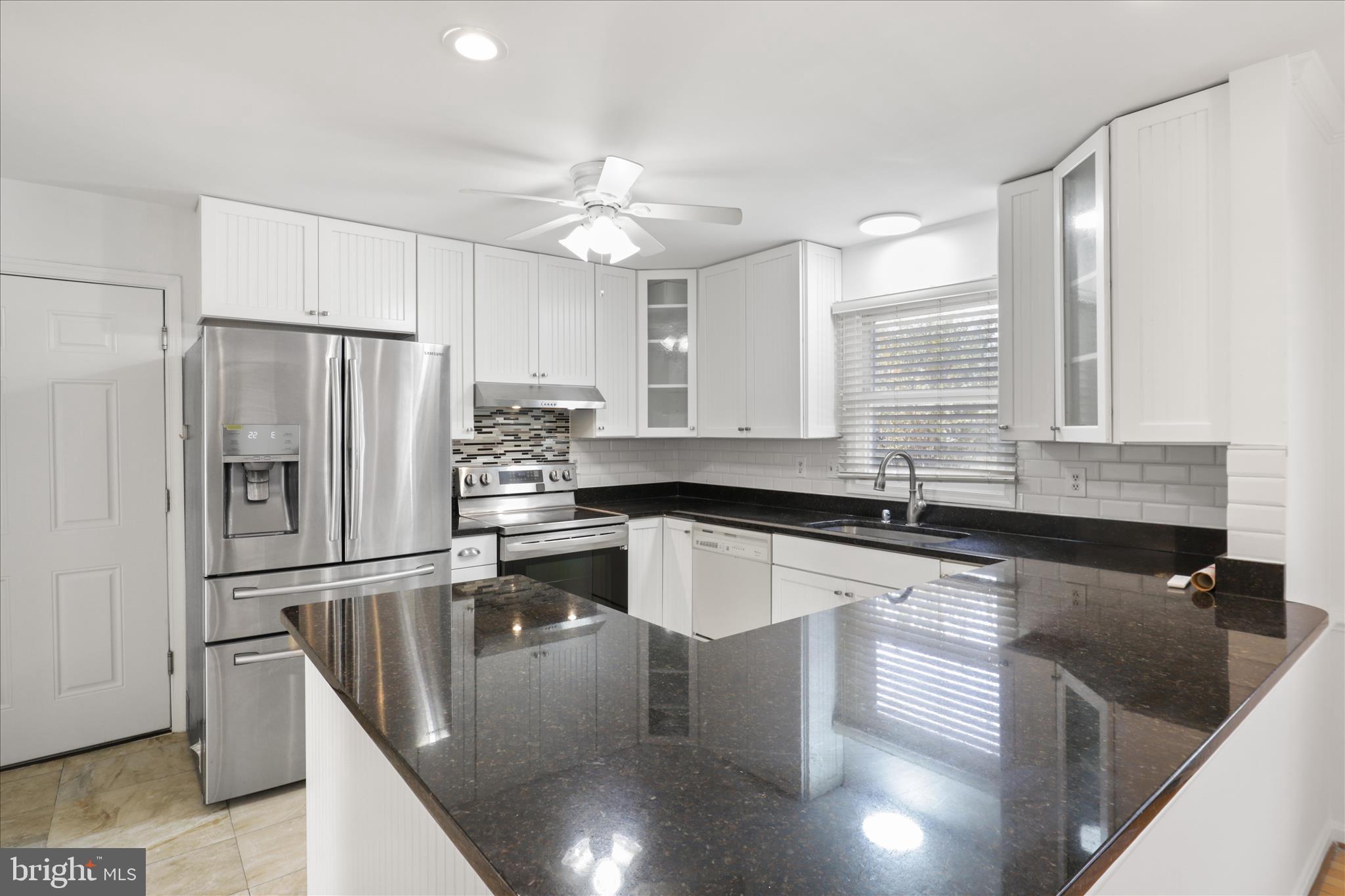 836 Utterback Store Road Great Falls, VA 22066 - Photo 2 of 30 a kitchen with granite countertop a sink stainless steel appliances and cabinets