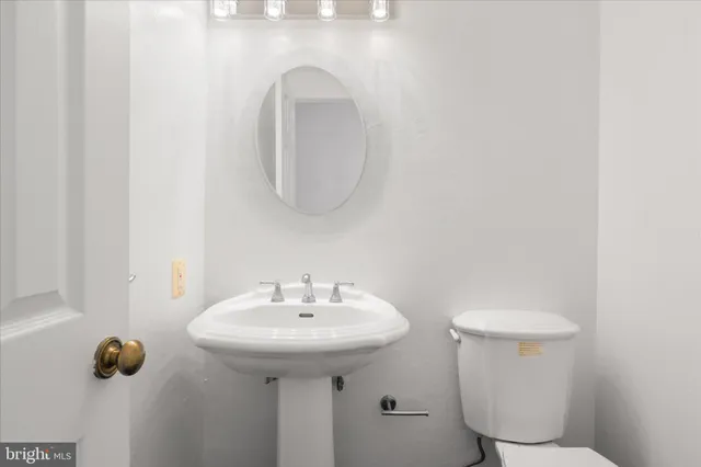 a bathroom with a sink toilet a mirror and shower