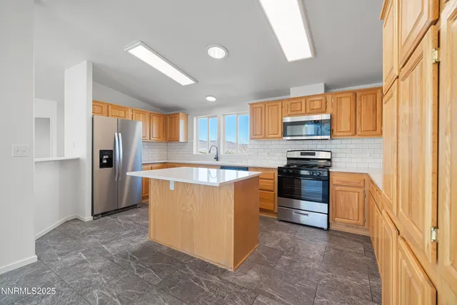 a kitchen with a sink a stove and cabinets