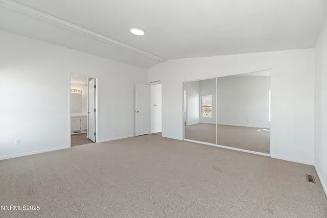 a spacious bathroom with a double vanity sink a mirror and a bathtub