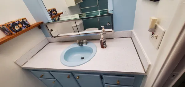 a bathroom with a sink and mirror