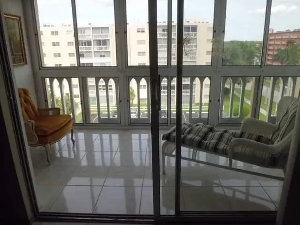 a view of an chairs and table in the balcony
