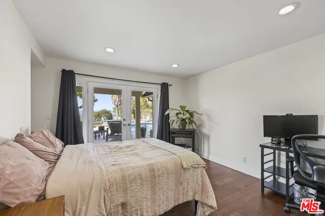 a spacious bedroom with a bed and a desk