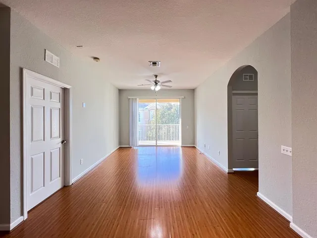 a view of a livingroom with wooden floor and a window