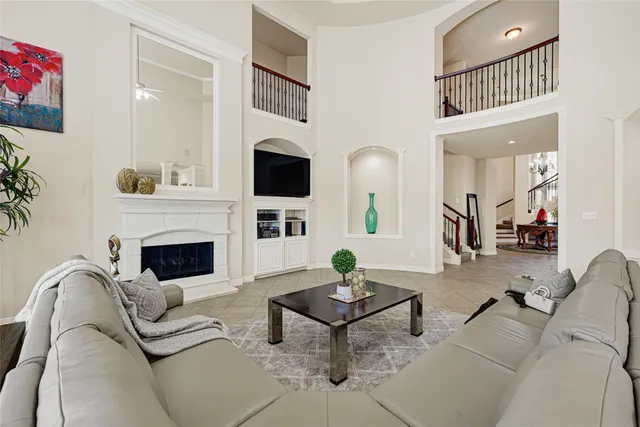 a living room with furniture a fireplace and a potted plant