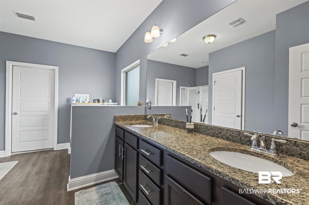 269 Silo Loop Fairhope, AL 36532 - Photo 6 of 17 Bathroom featuring vanity, a shower with shower door, and hardwood / wood-style floors