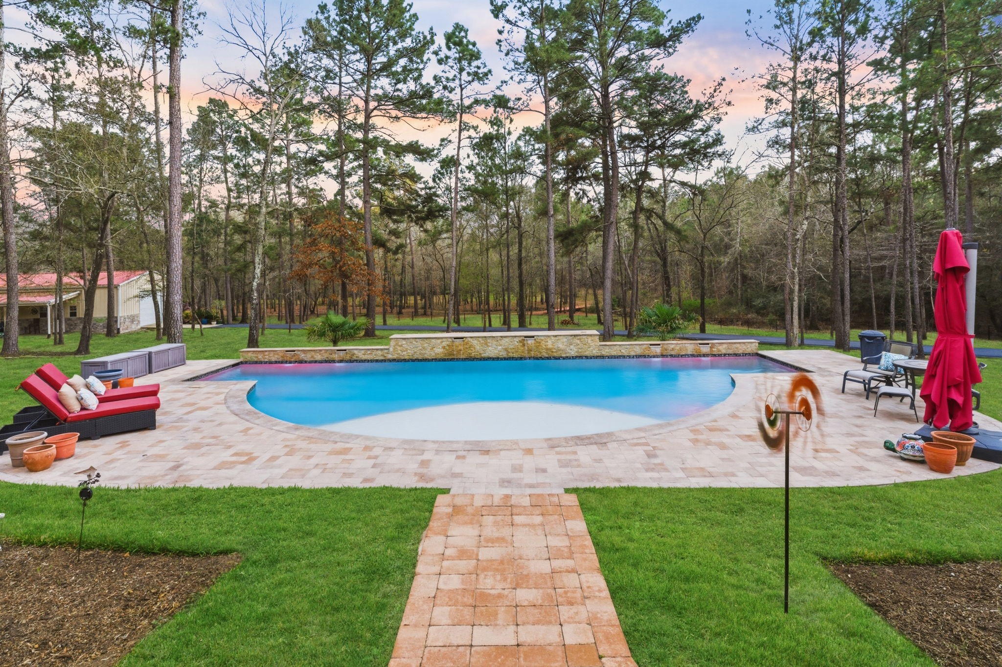 280 Sundog Road Huntsville, TX 77340 - Photo 42 of 50 Gorgeous resort-style pool with both heater and chiller offers refreshing swims during warm Texas days and comfortable enjoyment throughout the year.