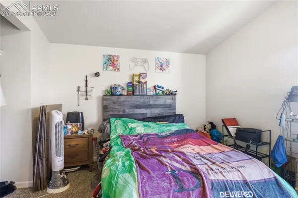 a bed sitting in a bedroom next to a window
