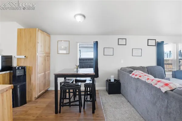 a living room with furniture and a dining table