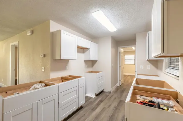 a kitchen with a sink stove and cabinets