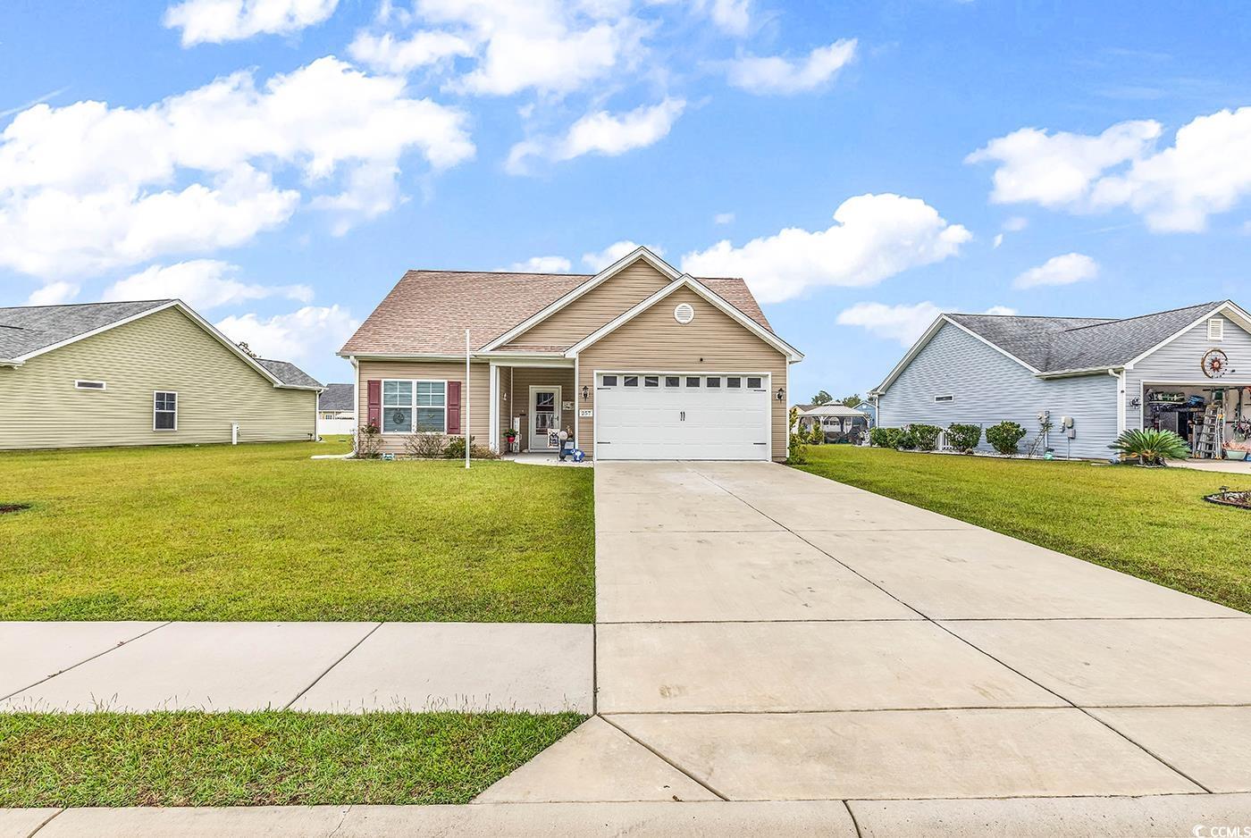 257 Maiden's Choice Drive Conway, SC 29527 - Photo 1 of 38 View of front of home with a front yard and a gara
