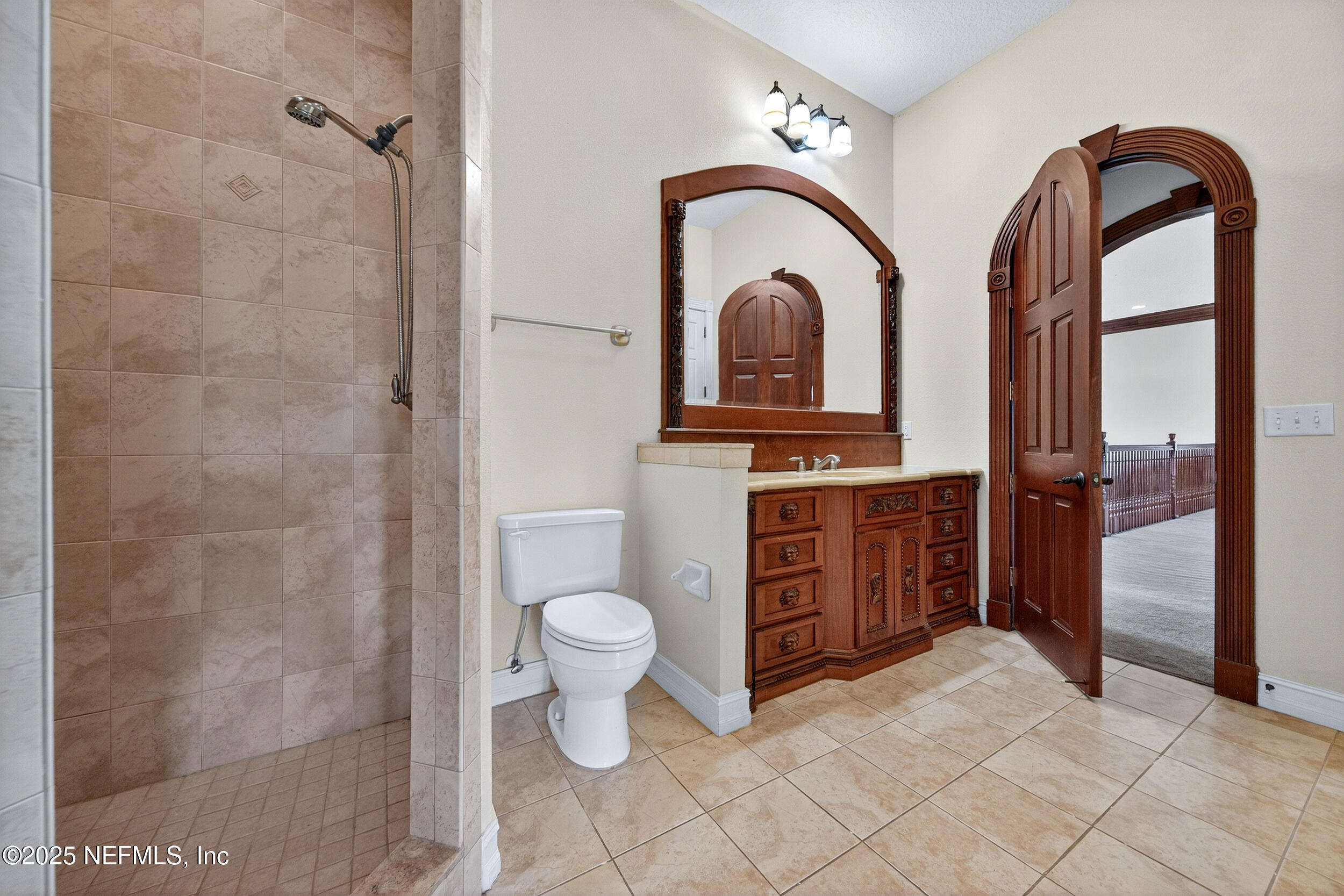45500 Stratton Road Callahan, FL 32011 - Photo 30 of 58 a spacious bathroom with a toilet a sink and a mirror