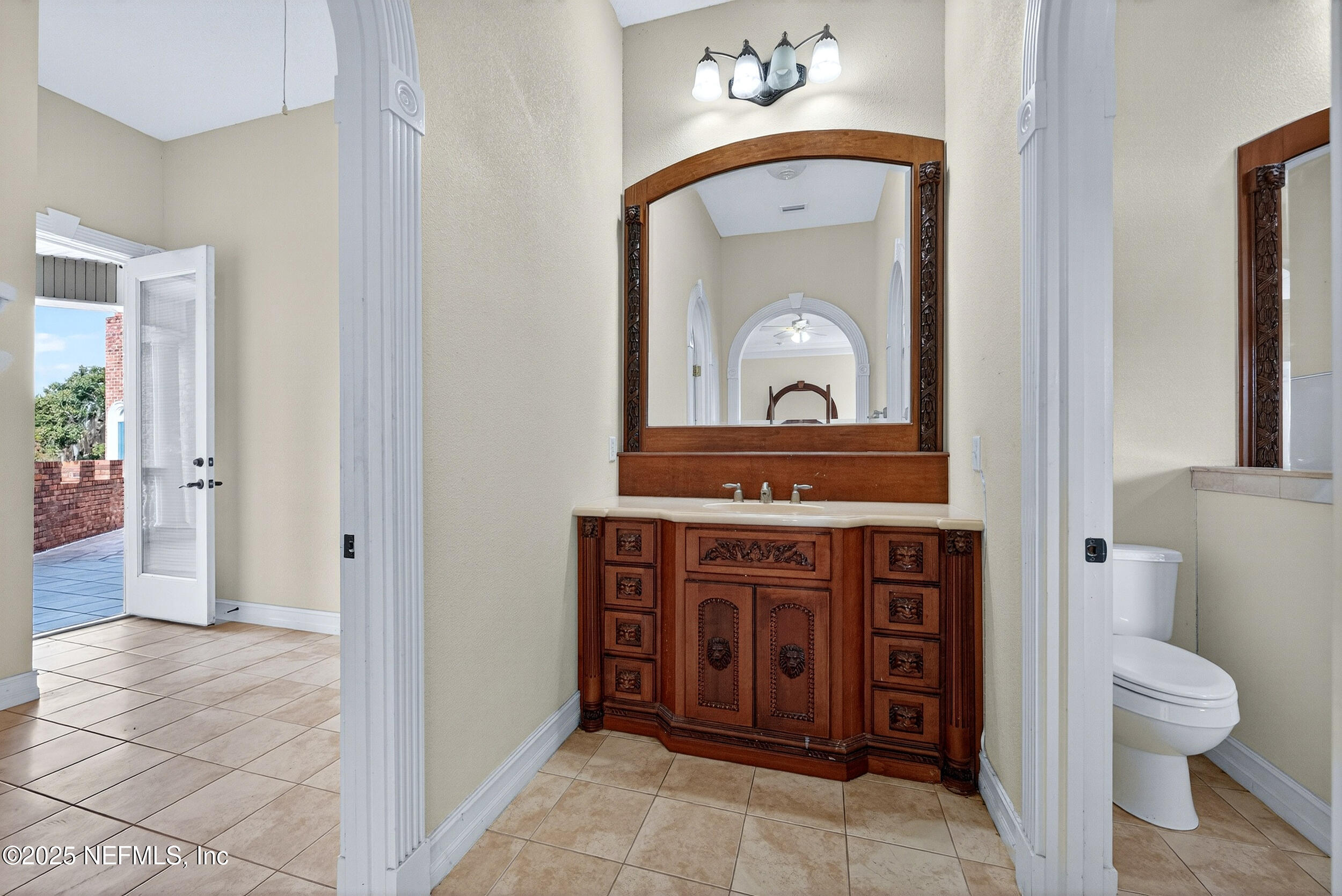 45500 Stratton Road Callahan, FL 32011 - Photo 32 of 58 a bathroom with a toilet a sink and a mirror