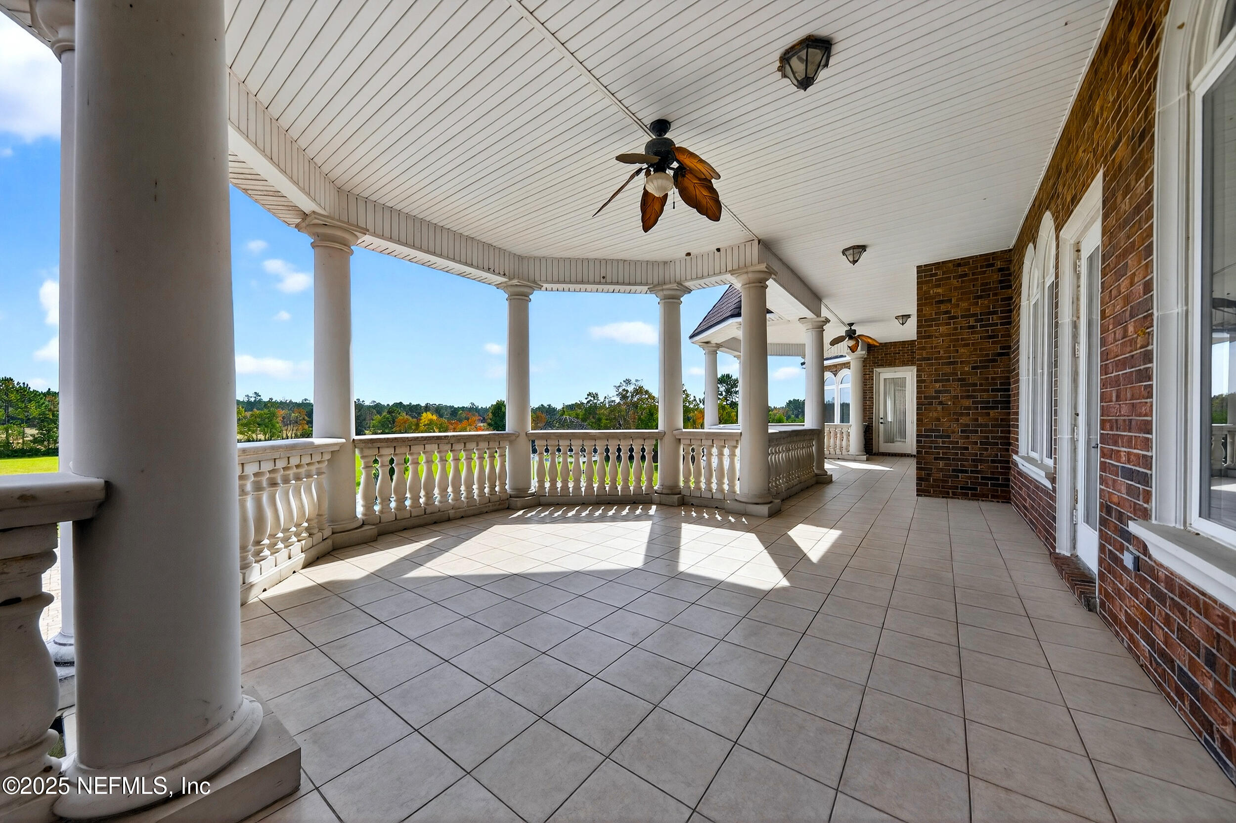 45500 Stratton Road Callahan, FL 32011 - Photo 48 of 58 a view of a porch with wooden floor and iron fence