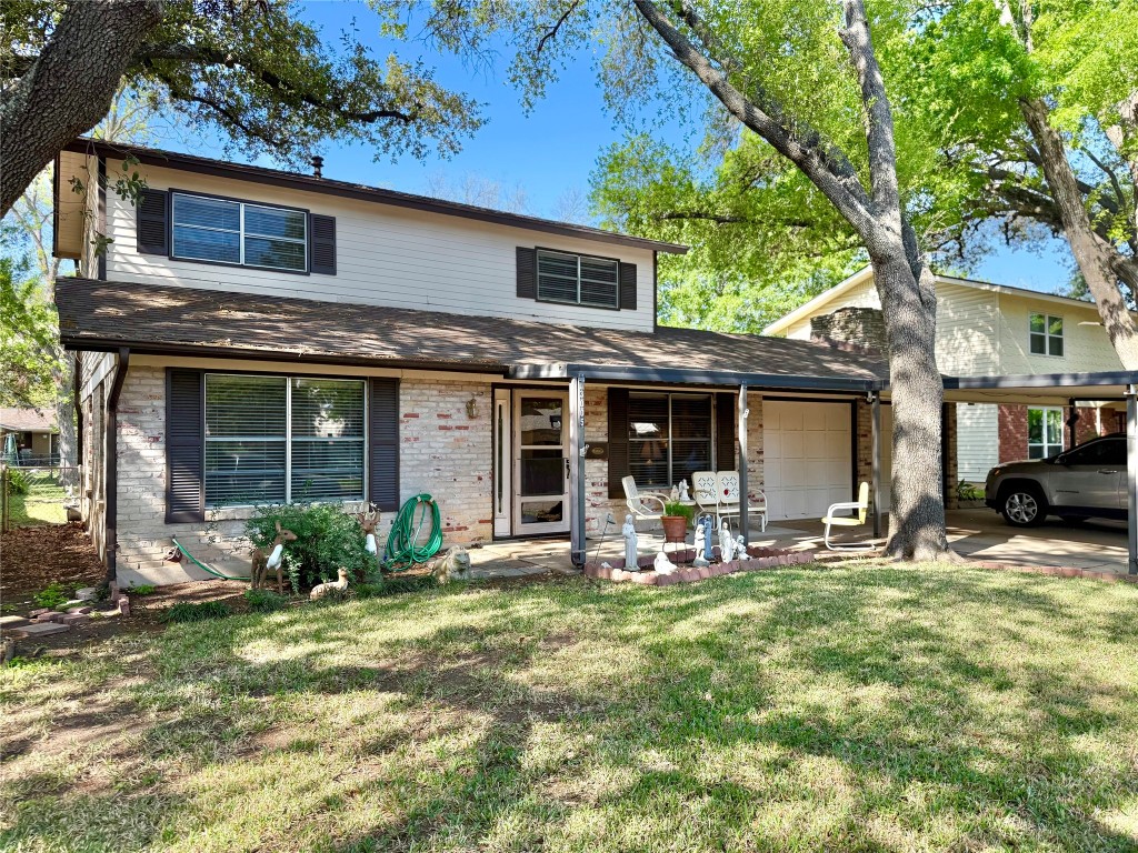 3005 Silverleaf Drive Austin, TX 78757 - Photo 1 of 1 a front view of a house with a garden and porch