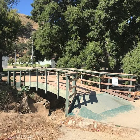 a view of a chairs and table on the wooden deck