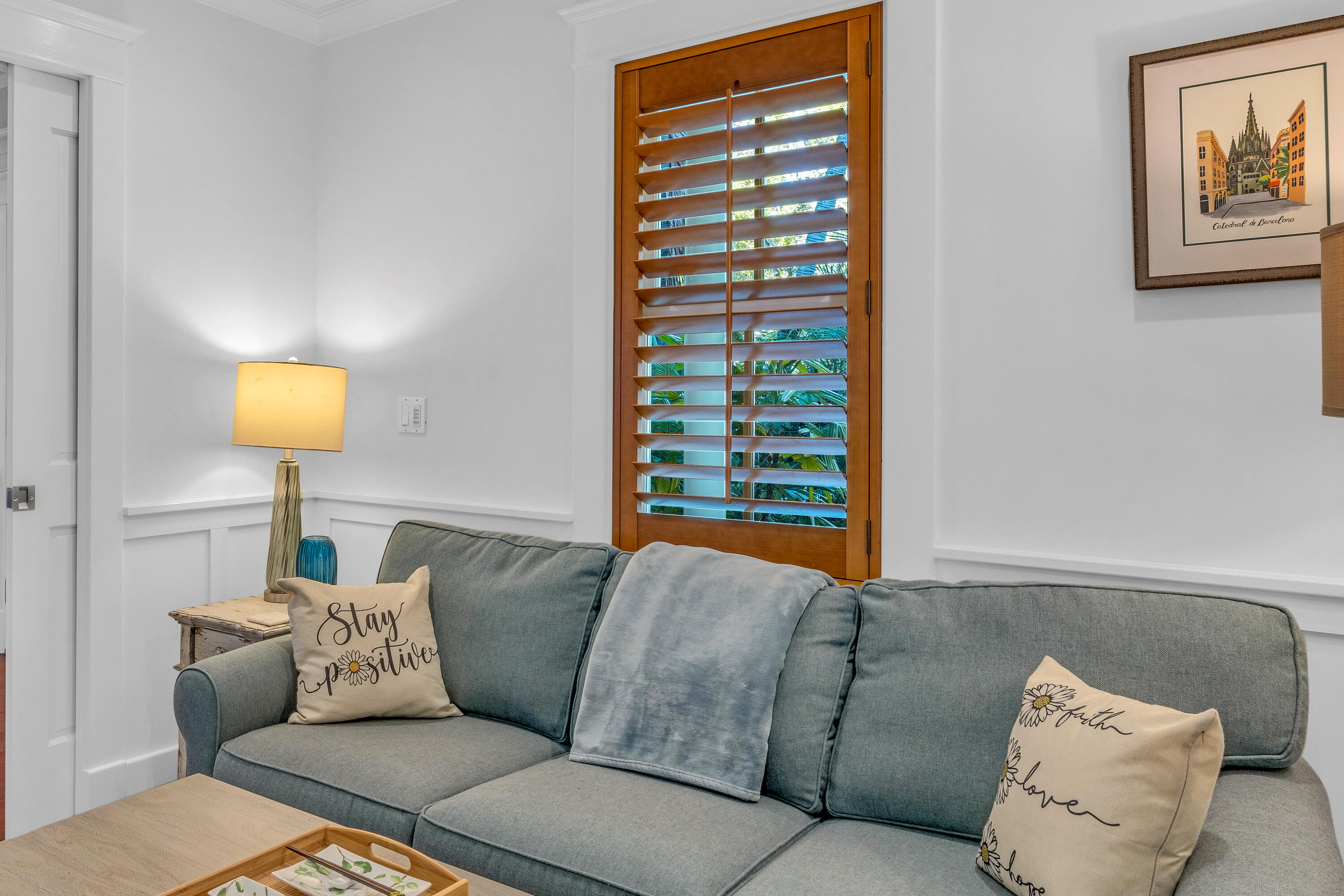 1416 White Street Key West, FL 33040 - Photo 24 of 61 a living room with a couch and a lamp next to a window