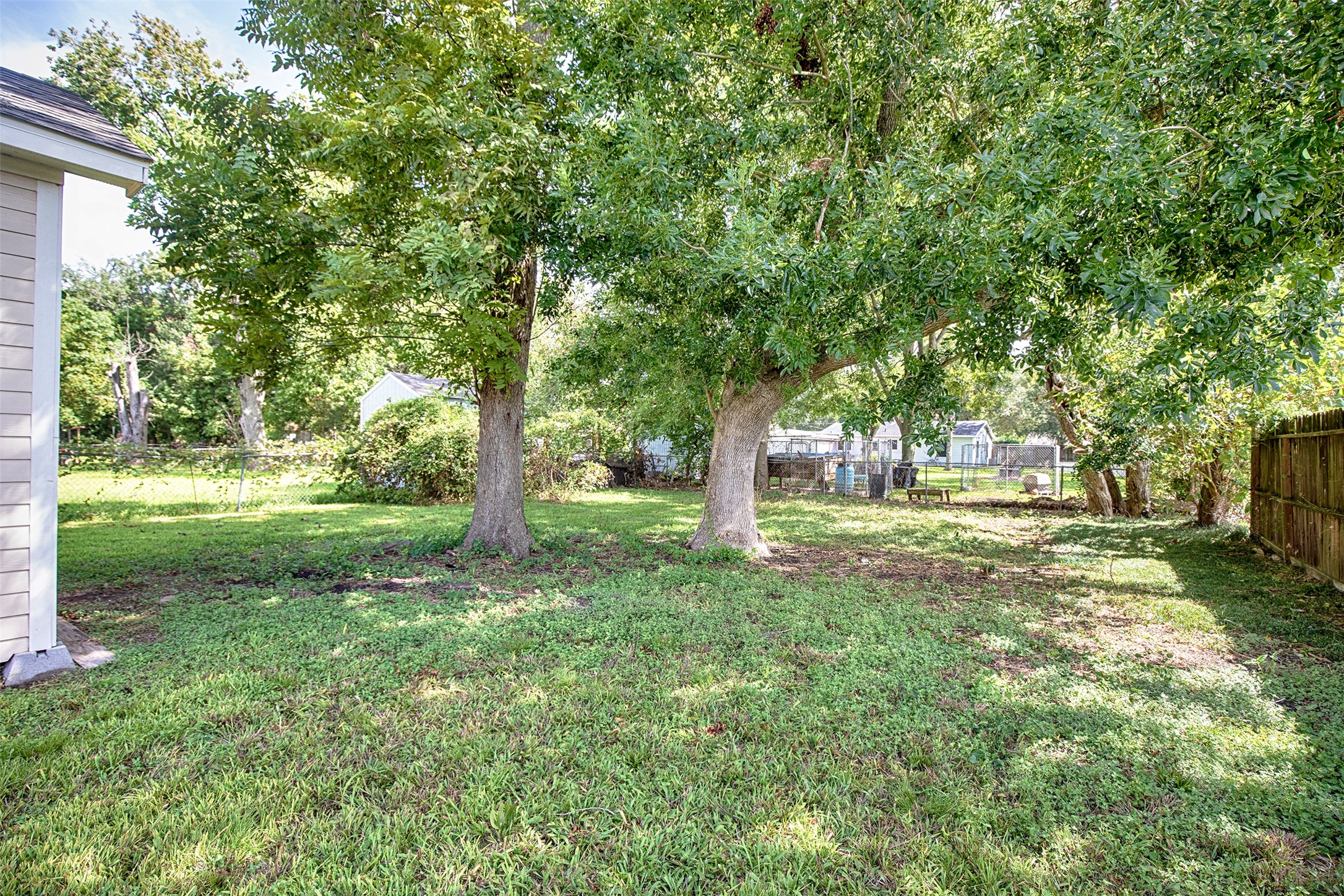 1125 Lake Road La Marque, TX 77568 - Photo 22 of 26 The mature trees in the backyard provide marvelous shade on a hot summer day.