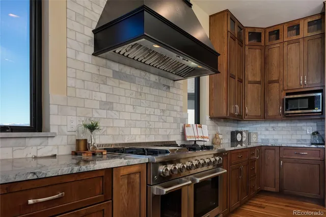 a kitchen with stainless steel appliances granite countertop a stove and a sink