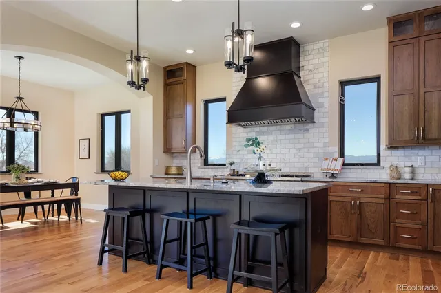 a kitchen with stainless steel appliances a sink a stove and a refrigerator